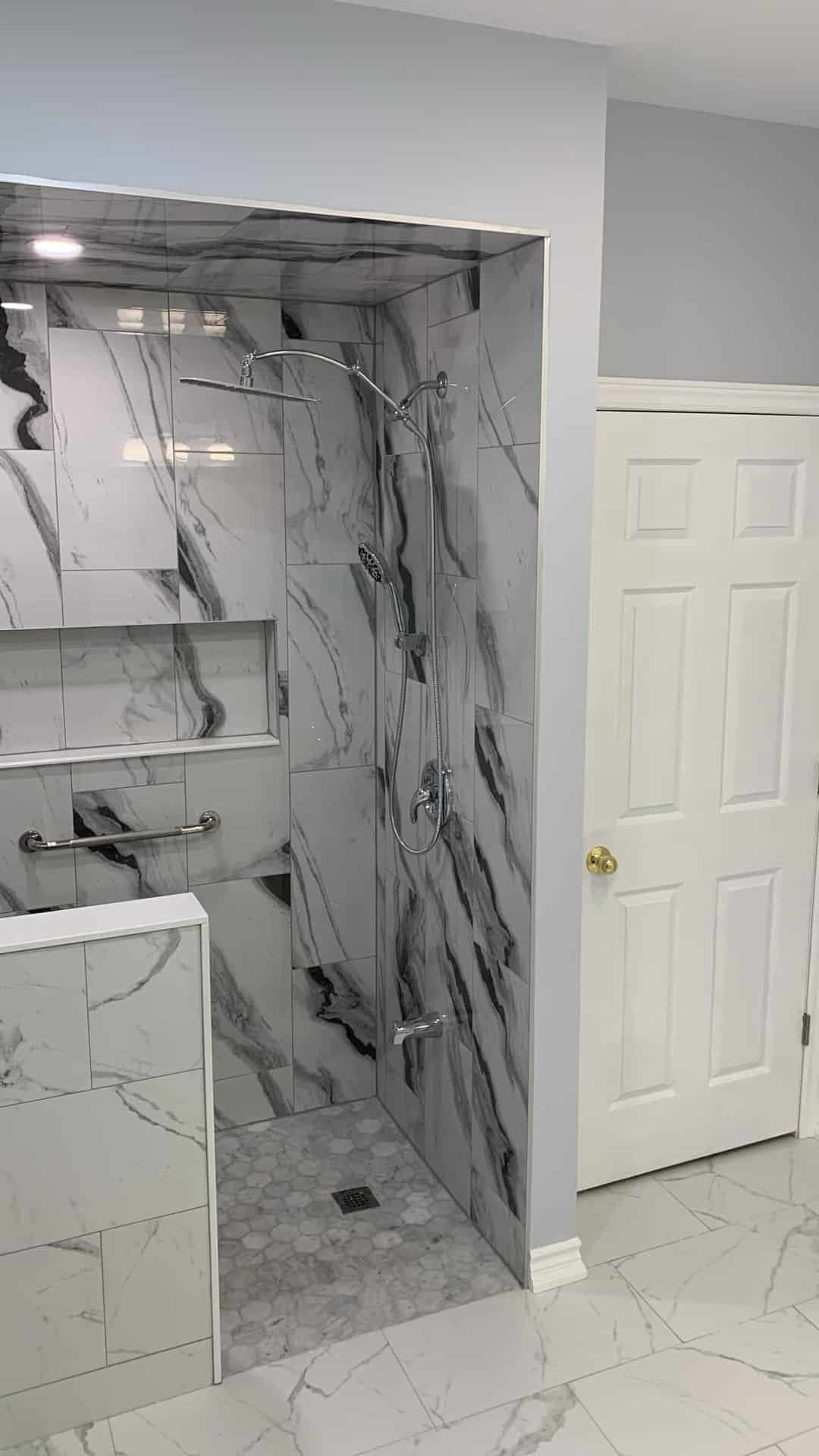 General Contractor St. Catharines Niagara Region 1 After: Black-veined marble walk-in shower with dual heads + grab bar—accessible luxury in Niagara Falls.